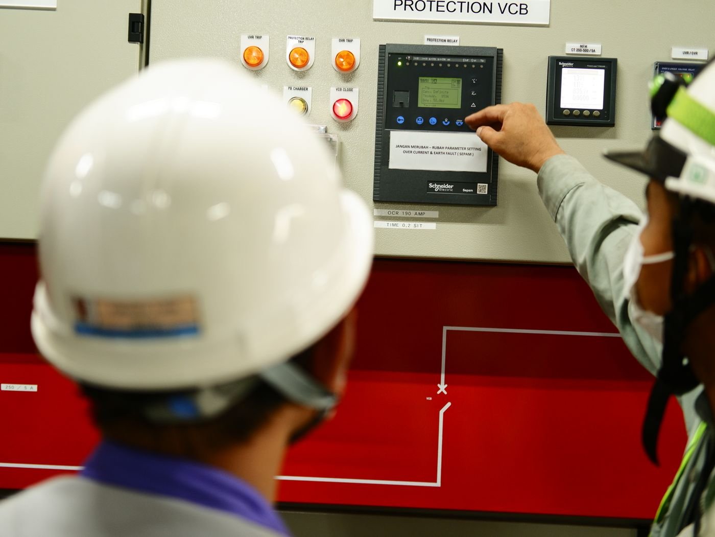 Engineer checking a control panel